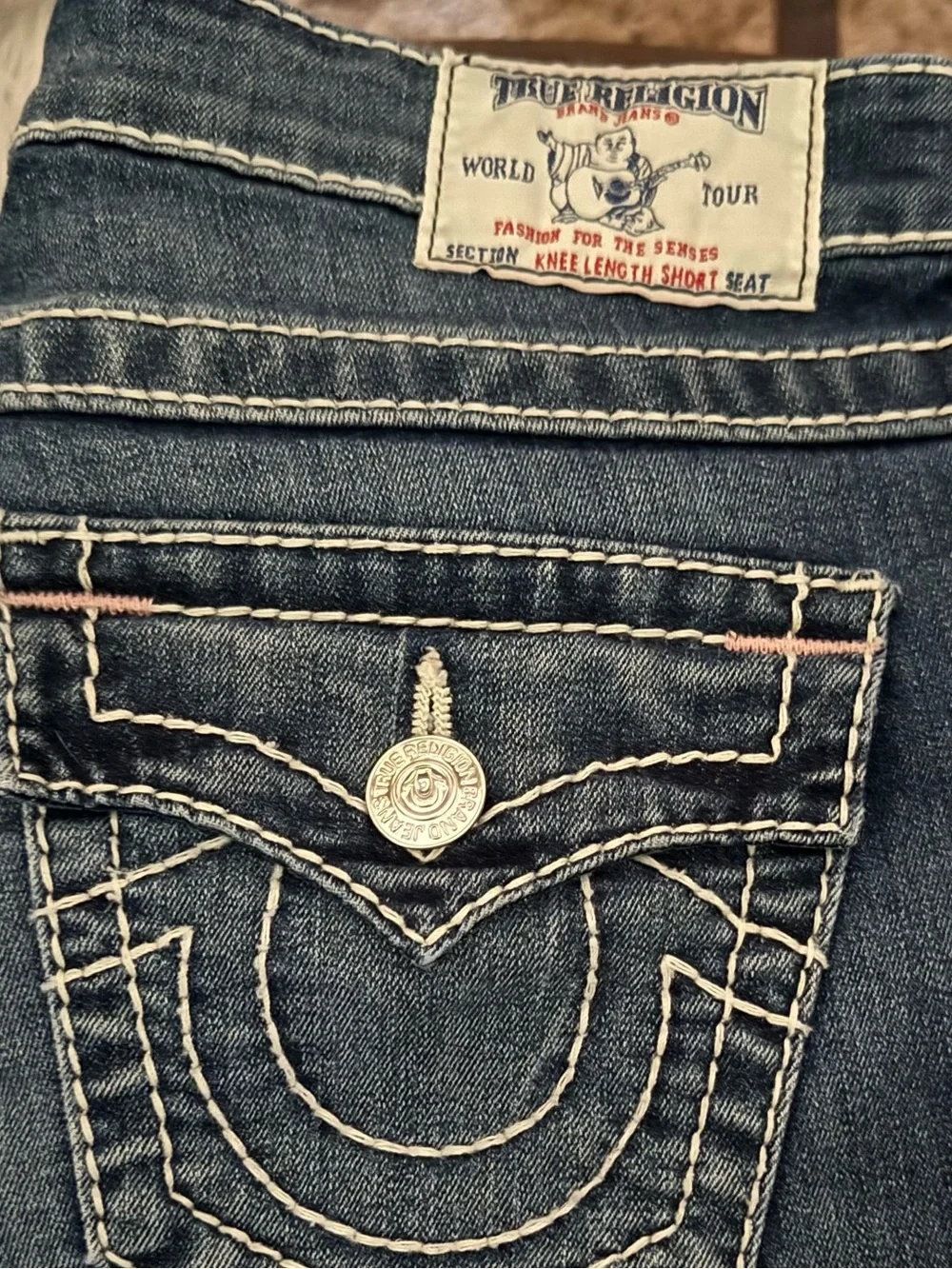 True Religion Women's Dark Indigo Boot Cut Jean Shorts with Contrast Stitching.